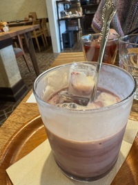 vegan purple milky drink with ice in a frosted glass