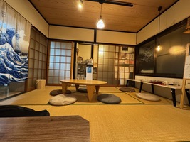 tiny restaurant with traditional japanese seating on tatami-mats. three small tables
