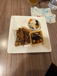 square plate with vegan pork chops, veggies and salad