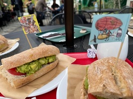 two avocado sandwiches with tiny flags stuck in them