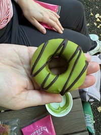 top view of green donut with stripes of chocolate across