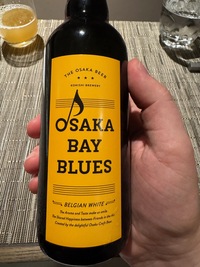 brown bottle of Osaka bay blues beer, yellow label with black writing