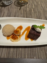 top view of a lozange shaped plate with desert cake and ice cream