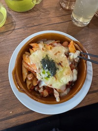 top view of grilled pasta dish in terracotta bowl