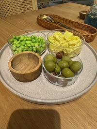 assorted dinner starters, edamame, olives, potato salad
