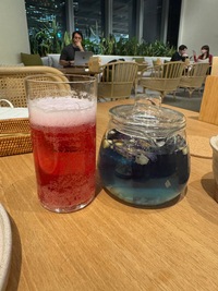 two drinks in glasses, one red one blue