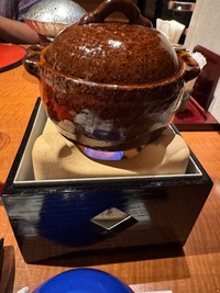 Kaiseki dinner: earthware pot and lid cooking over a spirtitus cooker 