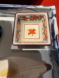 Kaiseki dinner: top view of a small empty square bowl with elaborate ornametnation and red bird illustration in the middle
