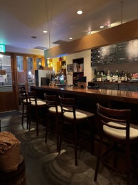 Dark wood panelled wine bar and chris