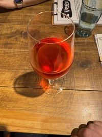wine glass filled with home made bright red  kombucha