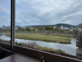 view of a wide riverbed through a tall window on a cloudy day