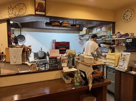 open kitchen in a small pizza restaurant with sole proprietor cooking