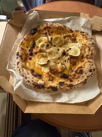 white vegan pizza with lemon slices