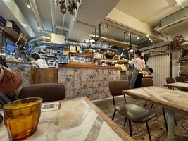 Small restaurant interior, main view of the open kitchen counter with staff