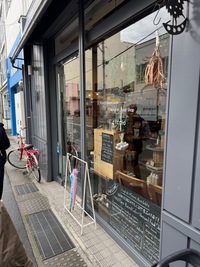 side view of a restaurant entrance with large window and grey walls